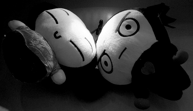 Photo of happy and sad dolls.